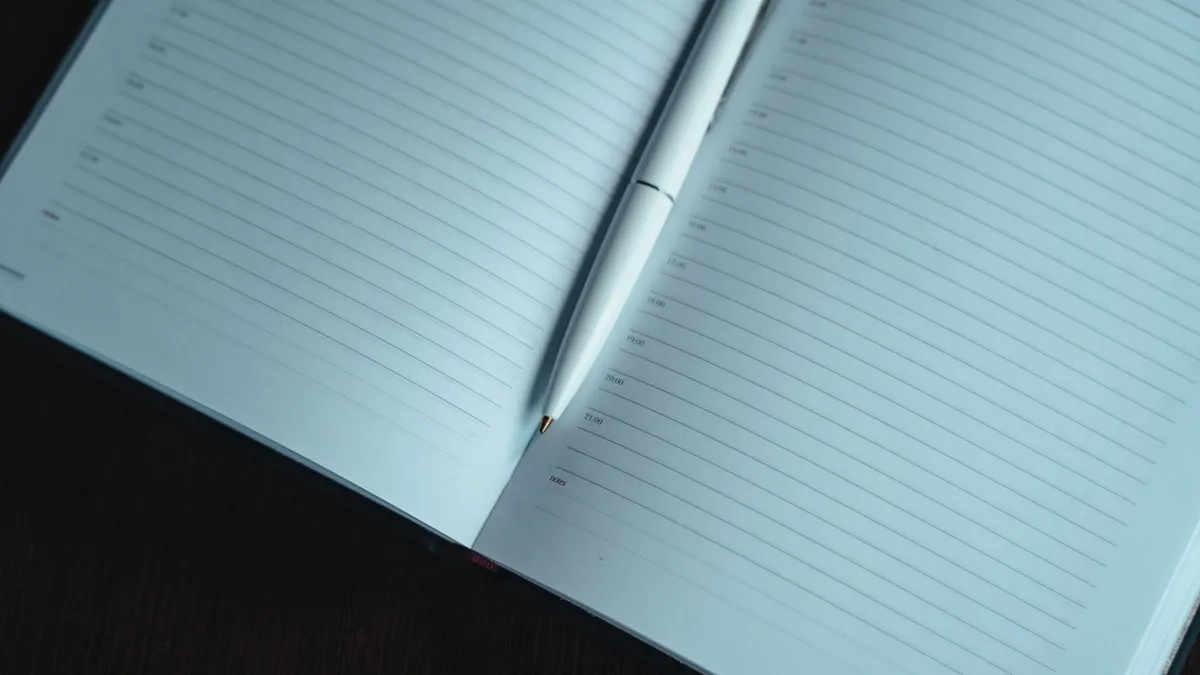 An open planner and pen