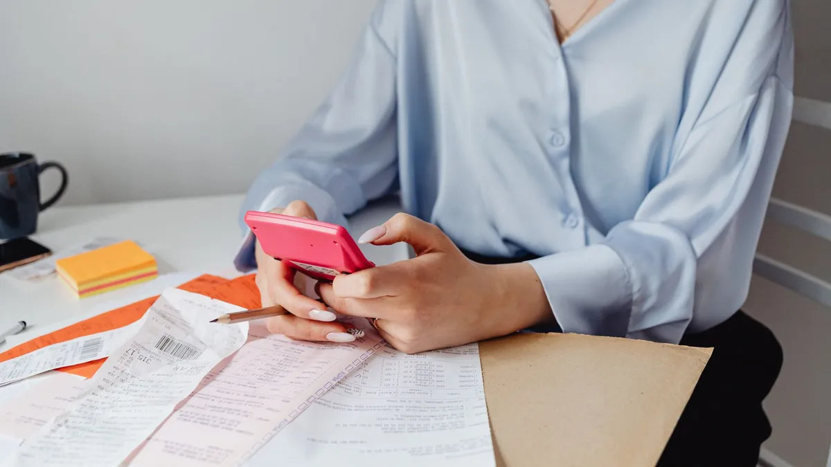 A person working through bills at a desk