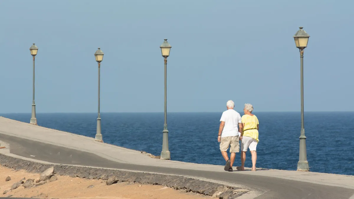 A retired couple walking together
