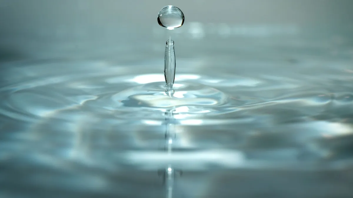 A water droplet creating ripples