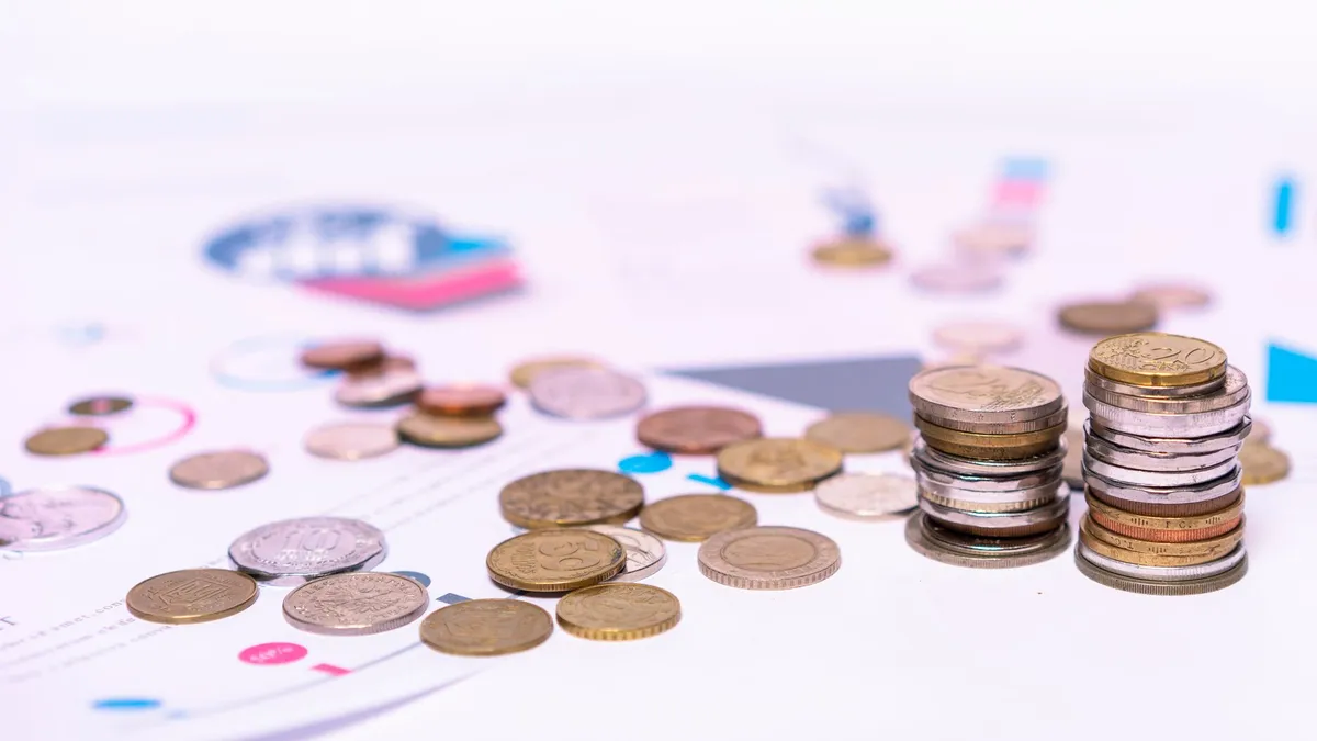 British pound coins beside a calculator