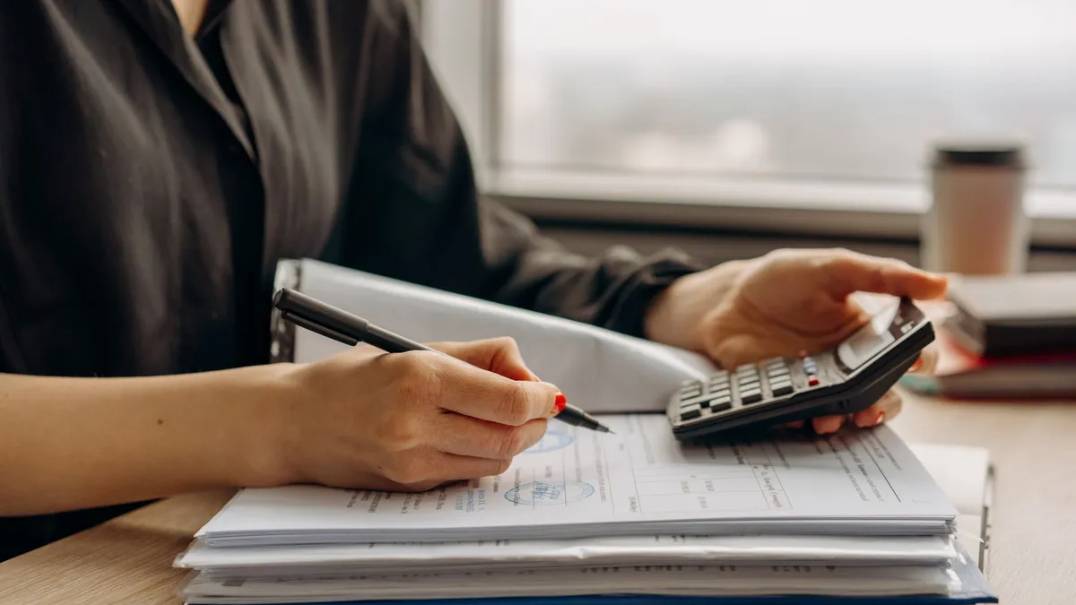 A calculator and paperwork on a desk