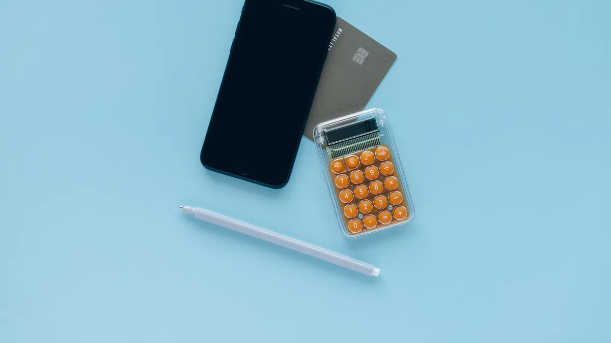 A credit card resting on a calculator